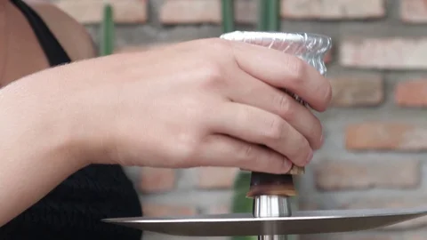 Hands put a bowl for a hookah Stock Footage 119556563