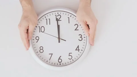 Hands put clock on table. Watch on white background top view Video stock 172491546