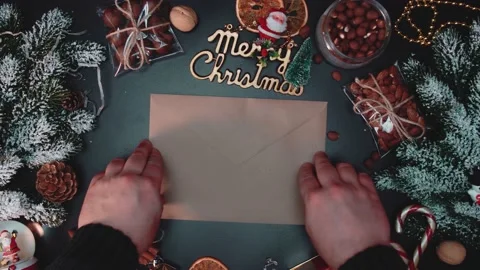 Hands put envelope on New Years table. Concept of New Year and Christmas. Stock Footage 145612933