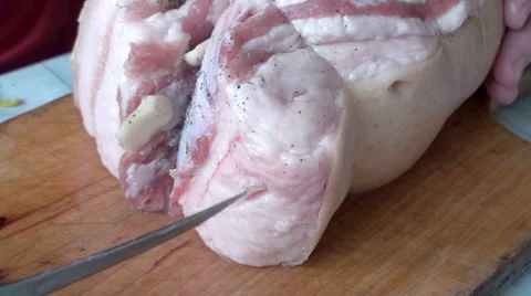 Hands put Garlic in a Piece of Meat. Stock Footage 67455598