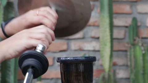 Hands put a hookah mine in a flask Stock-Footage 119556414