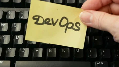 Hands put on keyboard sticker DevOps. DevOps Concept for software engineering Stock Footage 155805933