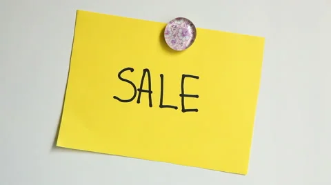 Hands put note with word Sale after quastion "Guess what?" on white board 스톡 동영상 65340209