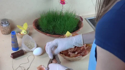 Hands put onion shell and white egg into sock Stock Footage 76749529