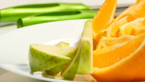 Hands put on a plate of apples, pears, oranges Stock Footage 78285680