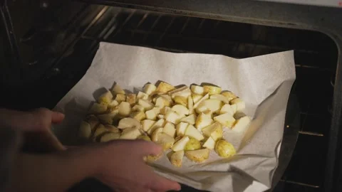 Hands put potatoes in the oven Stock Footage 164045798