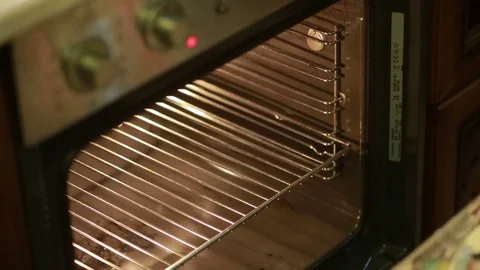 Hands put sliced vegetables into the oven Stock Footage 69998146