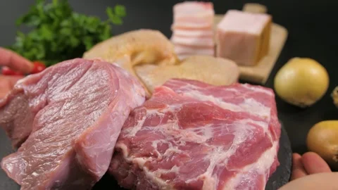 Hands put on a stone plate with pieces of raw meat of veal, pork, chicken. Stock Footage 185570810