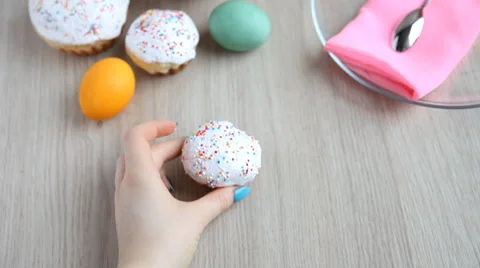 Hands put on the table Easter cake with white icing. Stock Footage 61749016