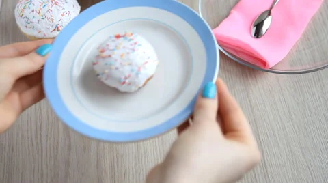 Hands put on the table a plate with a Easter cake with white icing. Stock Footage 61638704