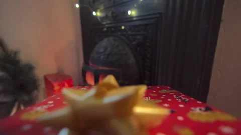 Hands puts red gift box near fireplace. Stock Footage 258599882
