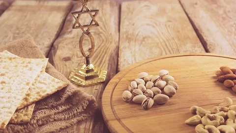 Hands puts the table on a round stand with nuts and sets the kiddush wine Stock Footage 151035804