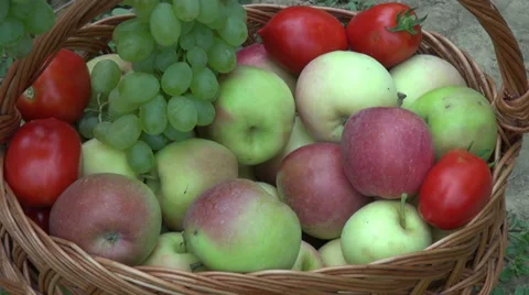 Hands putting apples and white grapes in a basket, fruits, farm, orchard,harvest Stock Footage 30591885