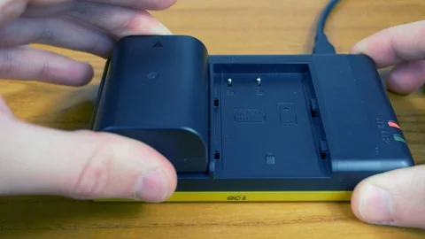 Hands that putting in charge two batteries Stock Footage 87378879