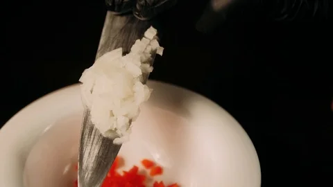 Hands putting chopped onion in the plate Stock Footage 125458445