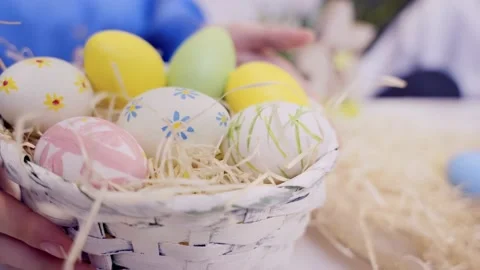 Hands putting down basket with colorful Easter eggs. Stock Footage 236341443