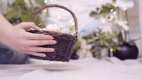 Hands putting down basket full of colorful eggs. Easter traditions. Stock Footage 236341714