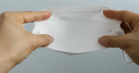 Hands putting on face mask to protect corona virus Stock Footage 126308496