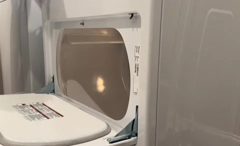 Hands Putting Laundry Into Dryer Stock Footage 222582992