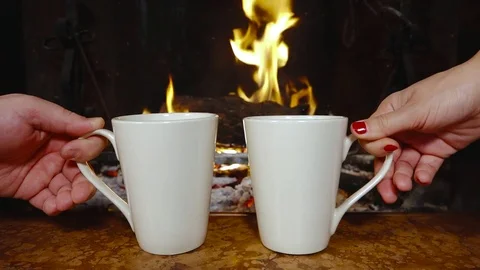 Hands putting mug fireplace warming winter holiday relaxing Видео 70755359