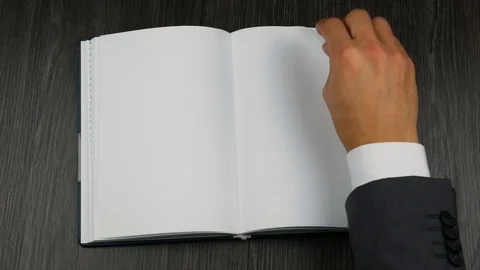 Hands putting an opened book on the table. Top view Stock Footage 96988918