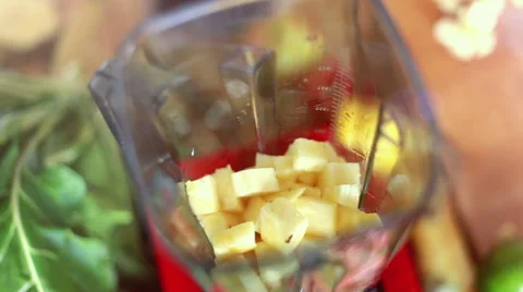 Hands putting pieces of pineapple in blender Stock Footage 59540458