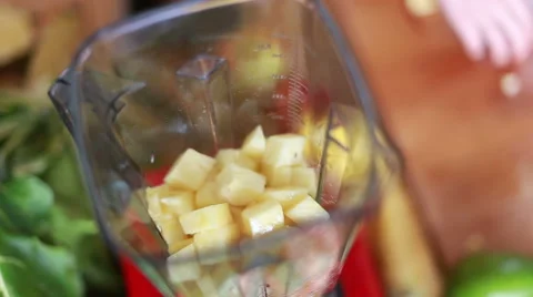 Hands putting pieces of pineapple in blender Stock Footage 59540459