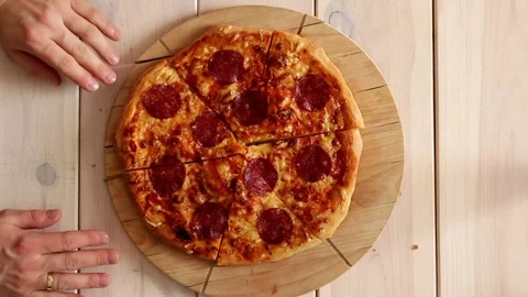 Hands putting pizza on plate Stock Footage 72458847