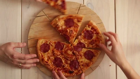 Hands putting pizza on plate Stock Footage 72458871