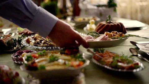 Hands putting platter with ham on table, super slow motion Stock Footage 103996041