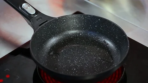 Hands putting raw chicken meat in a frying pan for cooking. Stock Footage 122095592