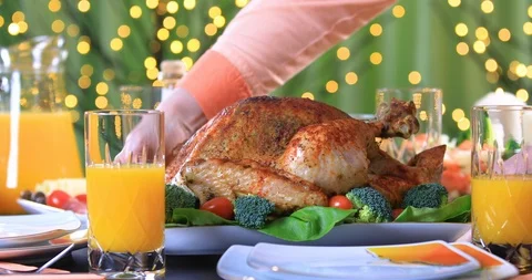 Hands putting roasted turkey on festive table closeup Stock-Footage 105603143