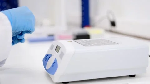 Hands putting samples in a machine Stock Footage 255196073