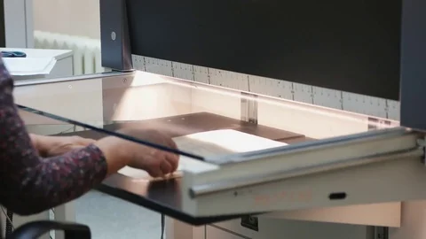 Hands putting a sheet of manuscript paper into high resolution scanning device Stock Footage 70672421
