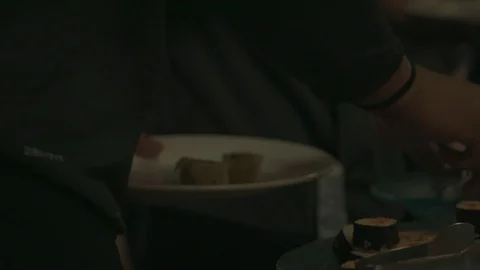 Hands putting sushi onto a plate Stock Footage 103879512