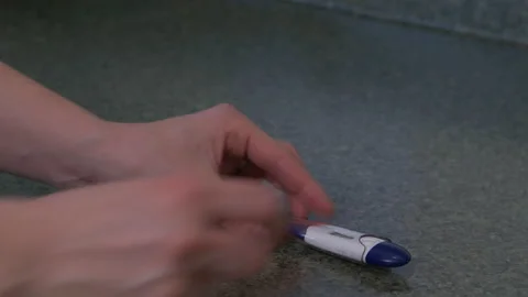 Hands putting thermometer in case Stock Footage 142540416