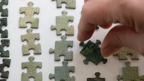 Hands putting together a puzzle on white background, method for collecting .. Vídeo Stock 332795091