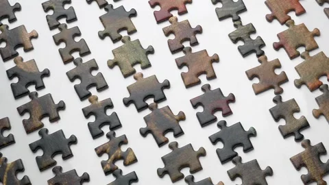 Hands putting together a puzzle on white background, method for collecting .. Stock Footage 332795123