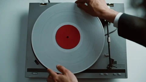 Hands putting vinyl disc at vintage gramophone placed on table closeup top view Stock Footage 332622967