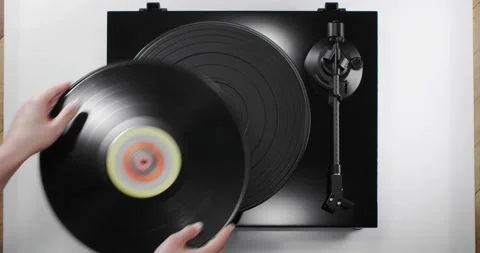 Hands putting vinyl record on black turntable, top view Stock Footage 155857110