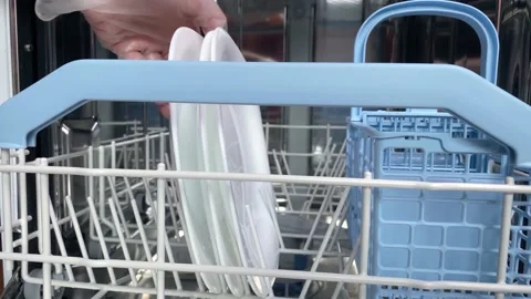 Hands putting white plates in dishwasher. Stock Footage 156316807