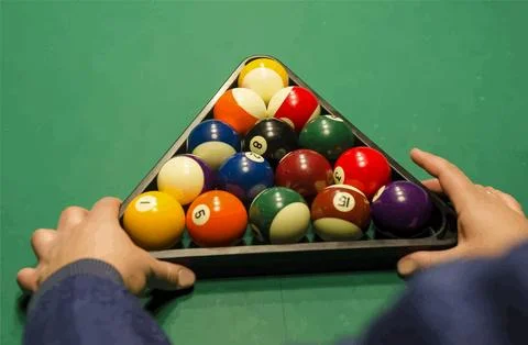 Hands Racking Billiard Balls on Green Pool Table Stock Photos