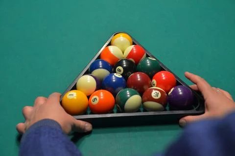 Hands Racking Billiard Balls on Pool Table Stock Photos