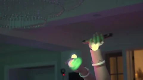 Hands raised in celebration create a glowing, vibrant party ambiance filled with Stock Footage 295009275