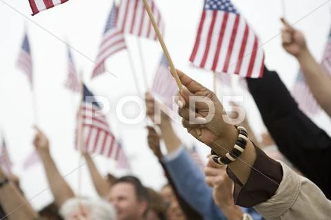 Hands Raising American Flag Stock-Fotos