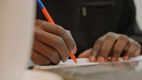 Hands rapidly illustrate ideas with orange ink on desk. Creative professional Stock Footage 338285285