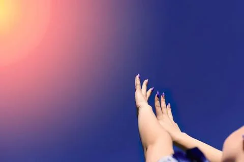 Hands reaching up with colorful gradient background Stock Photos