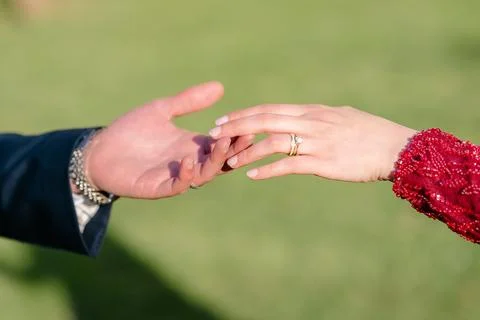 Hands Reaching for Connection in Outdoor Setting Foto stock