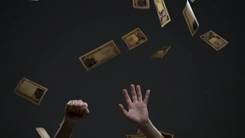 Hands reaching for falling Japanese banknotes against a black background Stock Footage 336765915