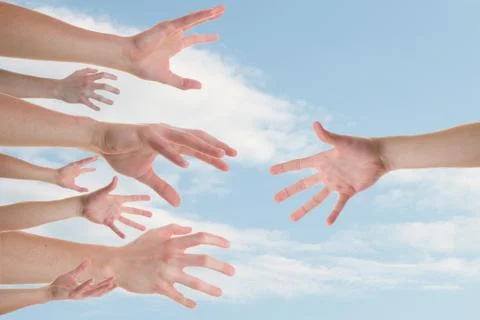 Hands reaching for a helping hand Stock Photos